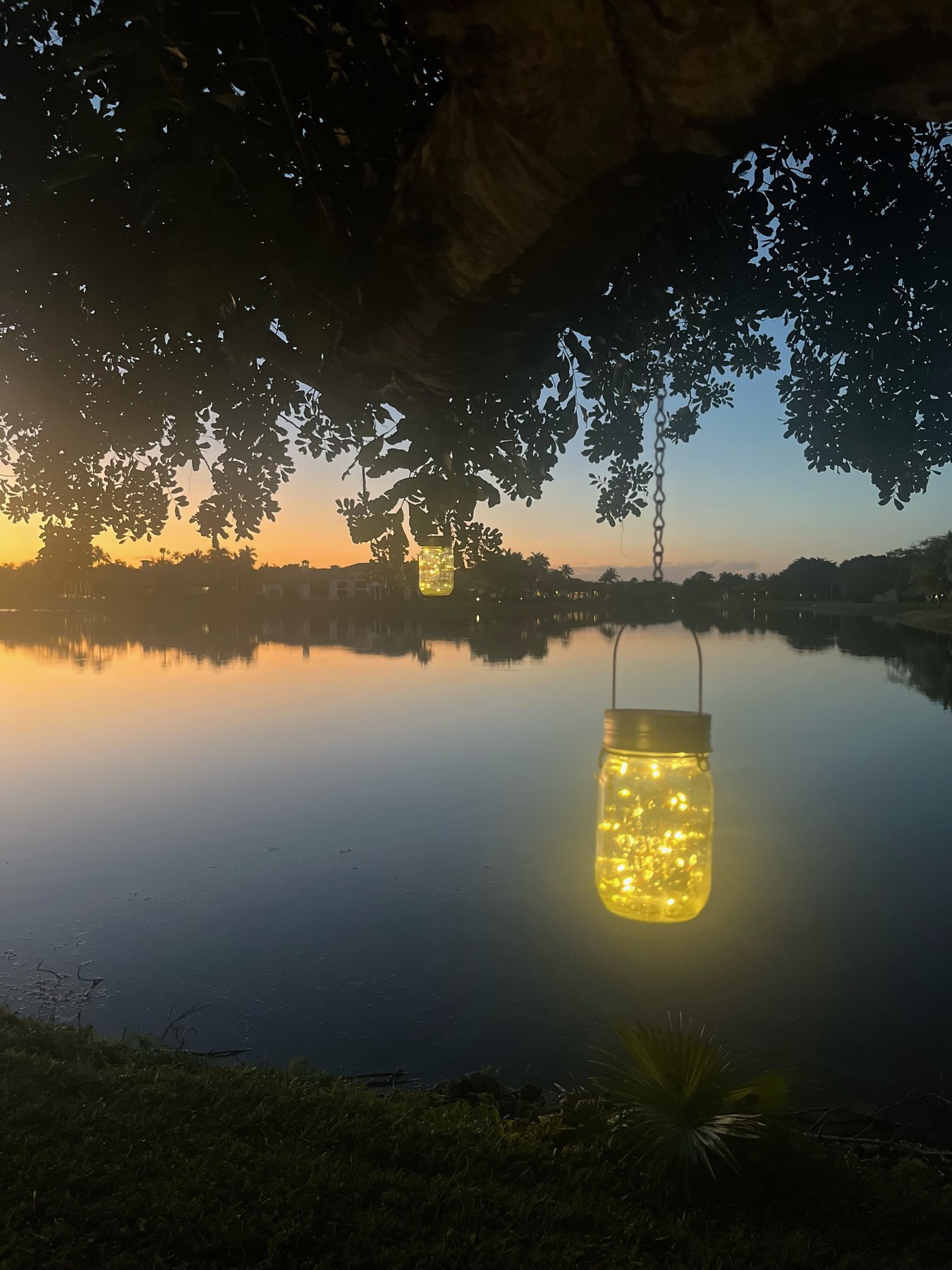 Mason jar lanterns over the lake at dusk
