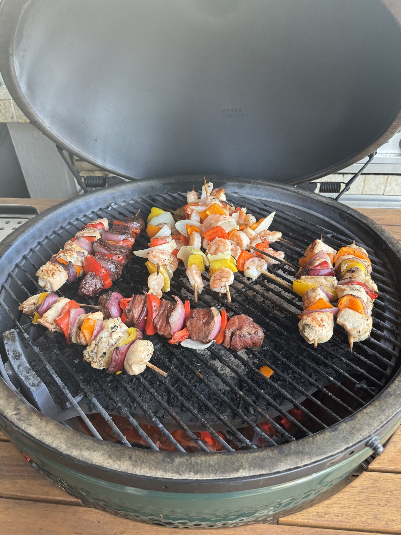 Steak, chicken, and shrimp kebabs on the grill