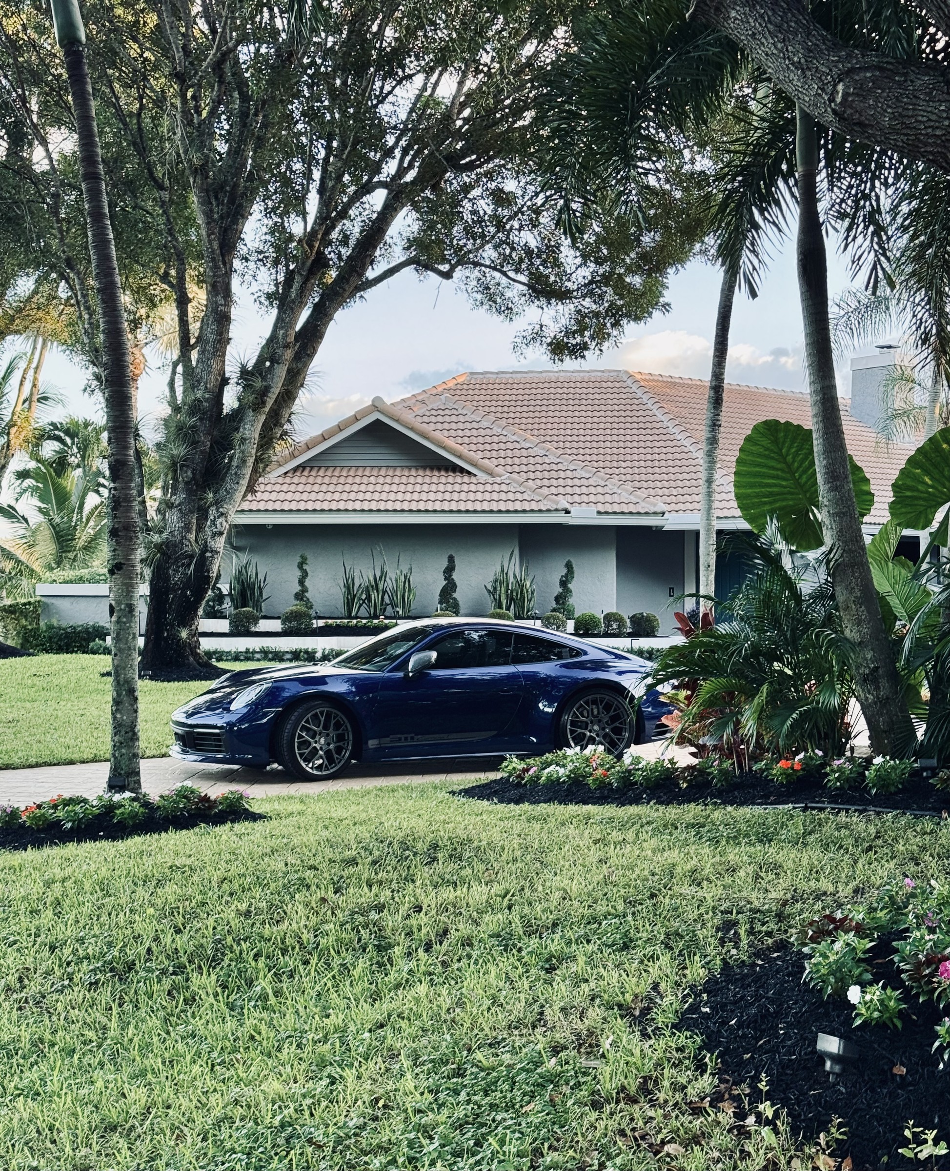 2024 Porsche 911 Carrera T in the driveway, framed by palms
